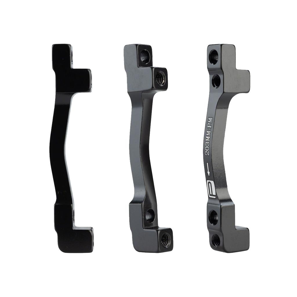 Three Promax PM for PM Disc Brake Adaptors (160/203 - 180/203) with mounting hardware are shown upright from different angles on a plain white background.