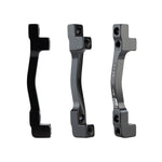 Three Promax PM for PM Disc Brake Adaptors (160/203 - 180/203) with mounting hardware are shown upright from different angles on a plain white background.