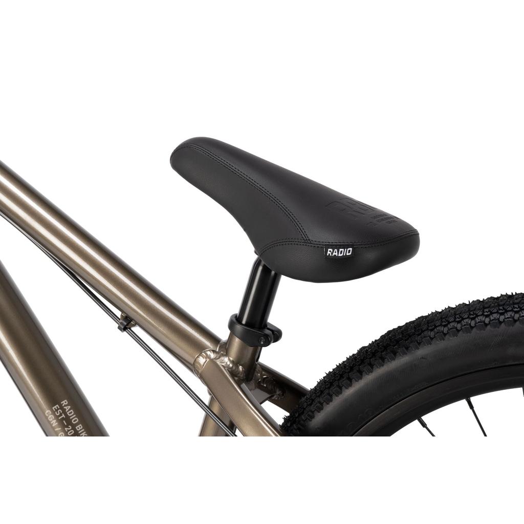 Close-up view of the Radio Griffin 24 Inch Dirt Jumper Bike seat attached to its metallic frame, with part of the rear tire and seat post visible.