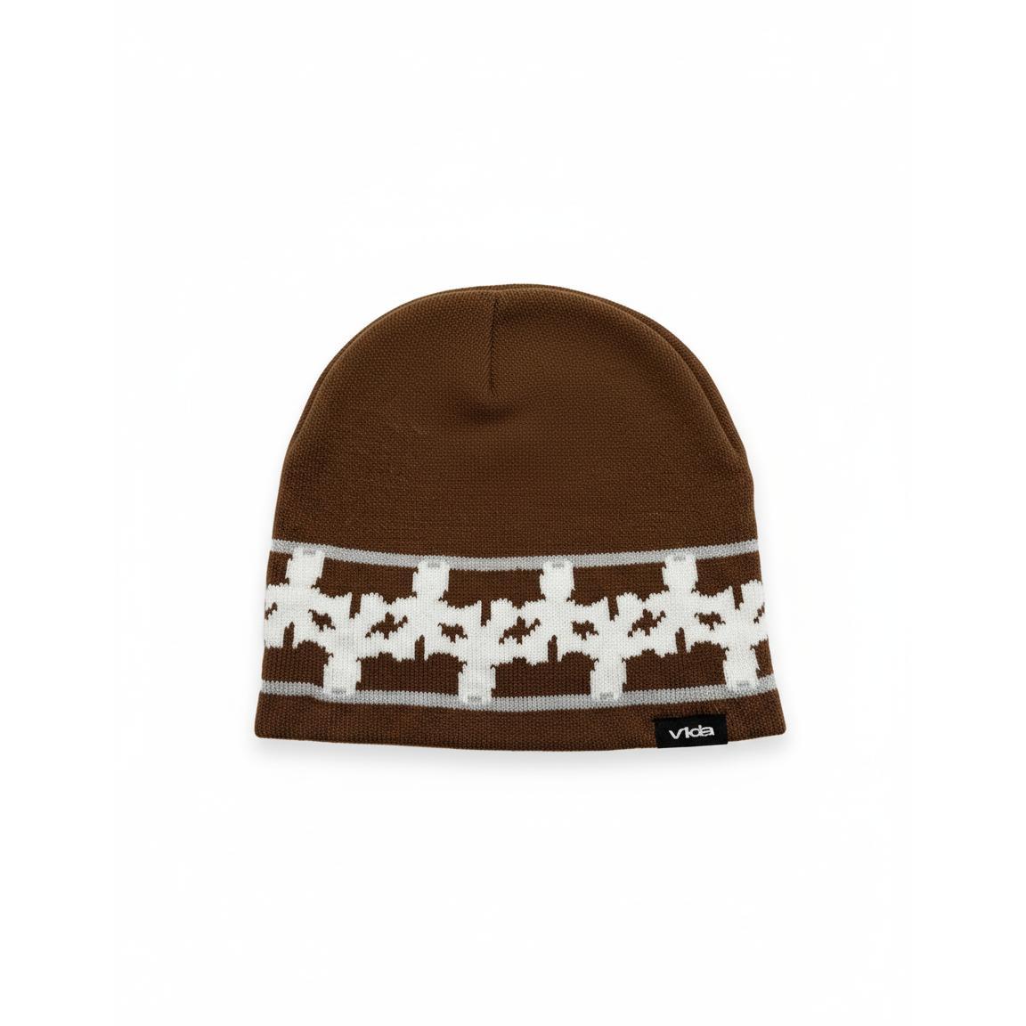 The V1da Pattern Beanie is a brown knit skully featuring a white geometric design and a black "Vida" tag on the bottom edge, shown against a white background.