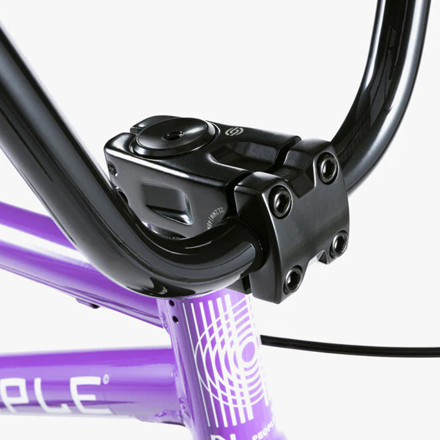 A purple Wethepeople Nova 20 Inch BMX Bike with a black handlebar.