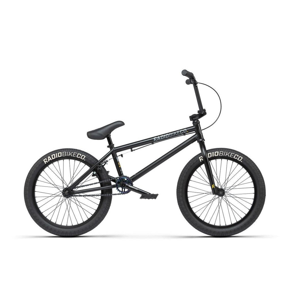 Description: The Radio Evol 20 Inch Bike, perfect for beginner riders, showcases "Radio Bike Co." branded tires, a padded seat, and straight handlebars. This black BMX bike is equipped with high-quality parts, a durable frame, and pegs on both the front and rear wheels.