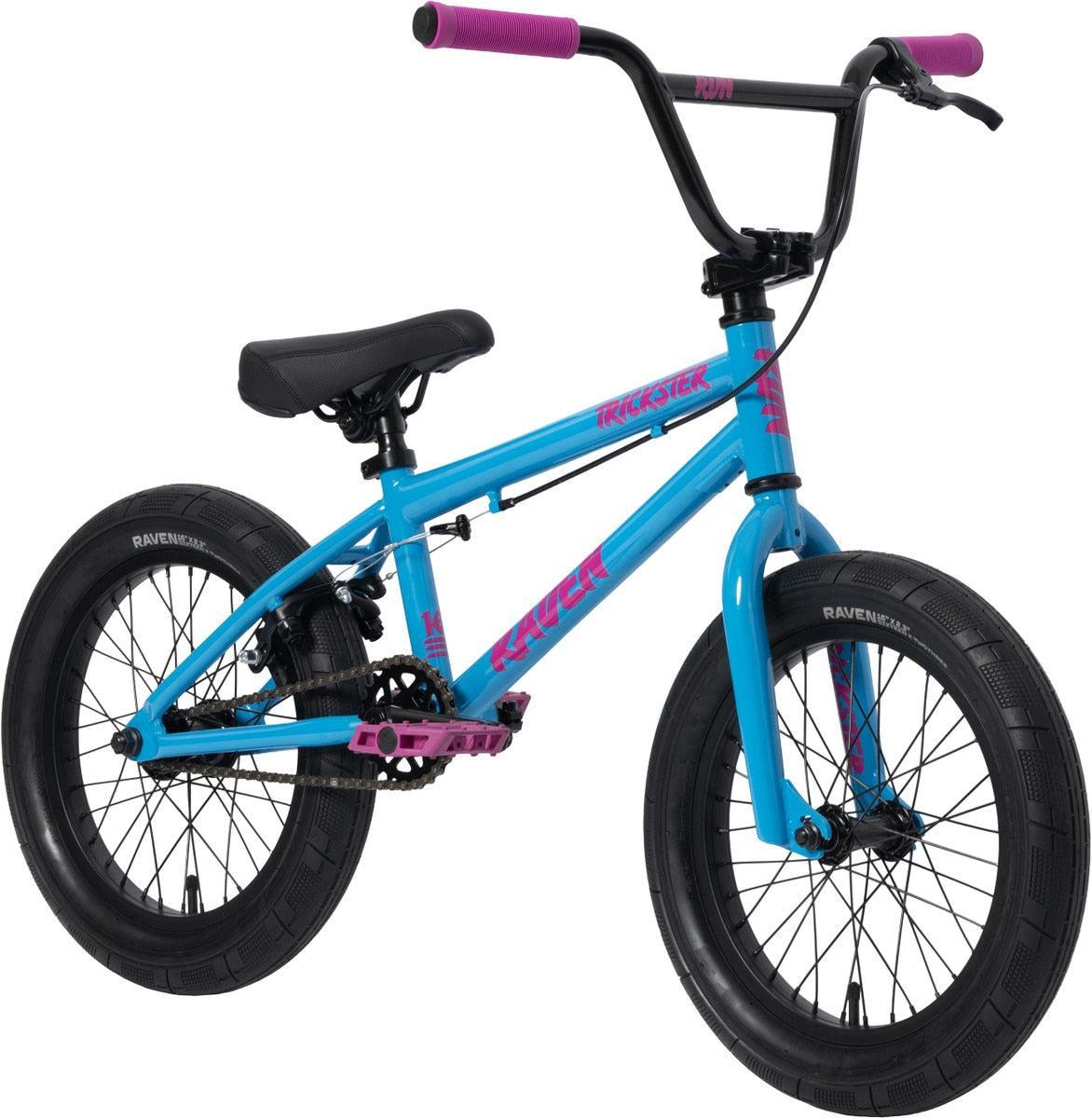 The Raven Trickster 16 Inch Bike is blue with black tires, pink handlebars, pedals, and detailing. It features durable chromoly cranks and is shown from a side angle against a white background.