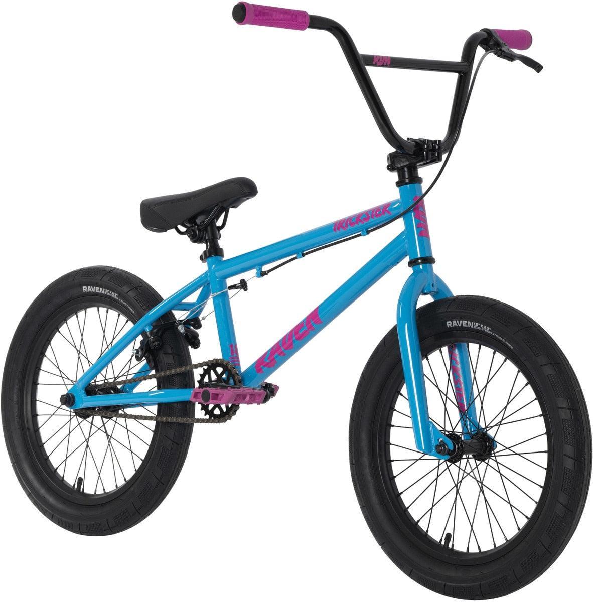 The Raven Trickster 18 Inch Bike is blue with black tires, seat, and handlebars with pink grips, pink pedals, pink accent text on the frame, chromoly cranks, and sealed bearing hubs for smooth performance.