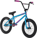 The Raven Trickster 18 Inch Bike is blue with black tires, seat, and handlebars with pink grips, pink pedals, pink accent text on the frame, chromoly cranks, and sealed bearing hubs for smooth performance.