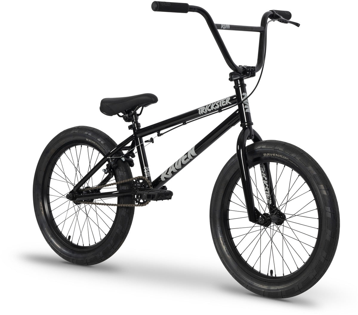 The Raven Trickster 20 Inch Bike is a black entry-level BMX with thick tires, rear axle pegs, and bold “Trickster” and “Raven” branding on the frame—perfect for beginner BMX riders. Shown on a white background.