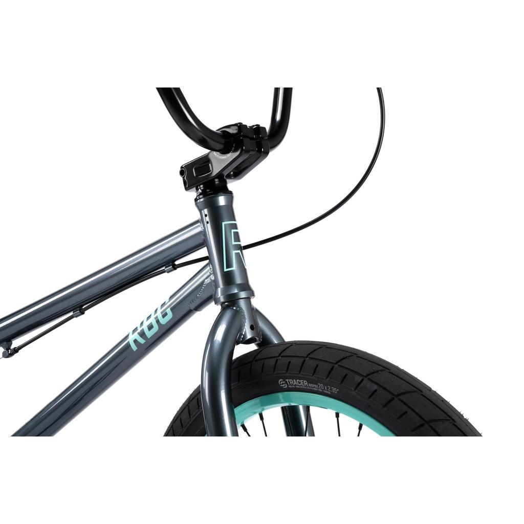 Close-up of the front part of the Radio Saiko 20 Inch Bike, a gray kids BMX with black handlebars and Salt Tracer Tyres, featuring light blue rim accents.