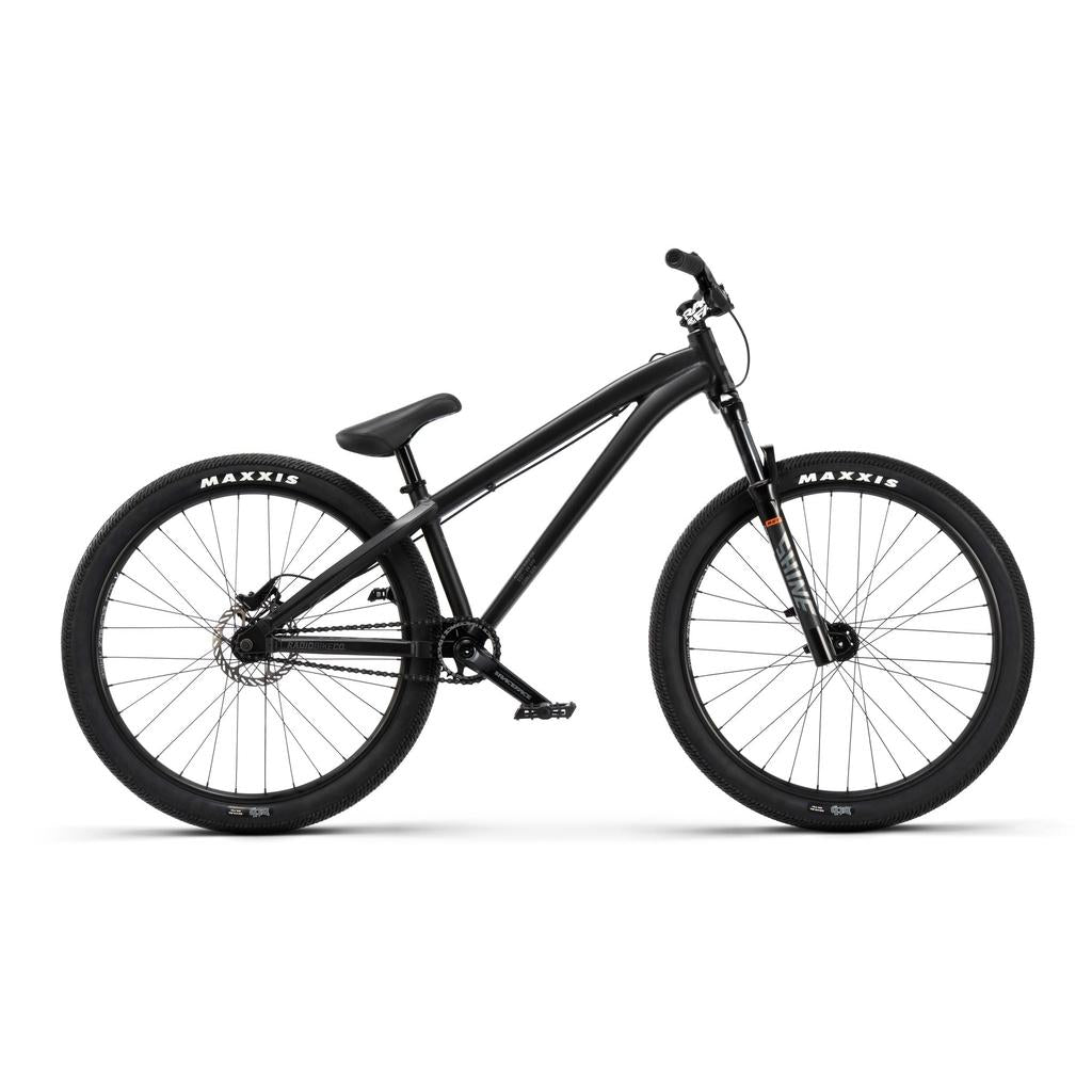 A side view of the black Radio 26 Inch Griffin Pro Bike, featuring an alloy frame, large tires, front suspension, flat pedals, and a sloped top tube, photographed on a white background.