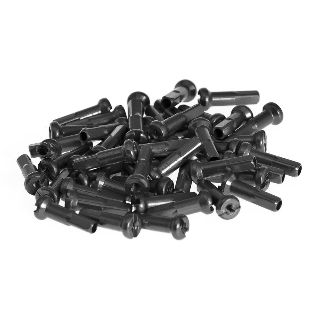 A pile of black plastic LEGO Technic connector pins scattered on a white background, mirroring the precision and organization seen in Salt Alloy Nipple (40 Pack) aftermarket spoke nipples.