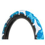 A blue and white Salt Tracer 18in Tyre (Each) with a camouflage pattern featuring directional tread design.