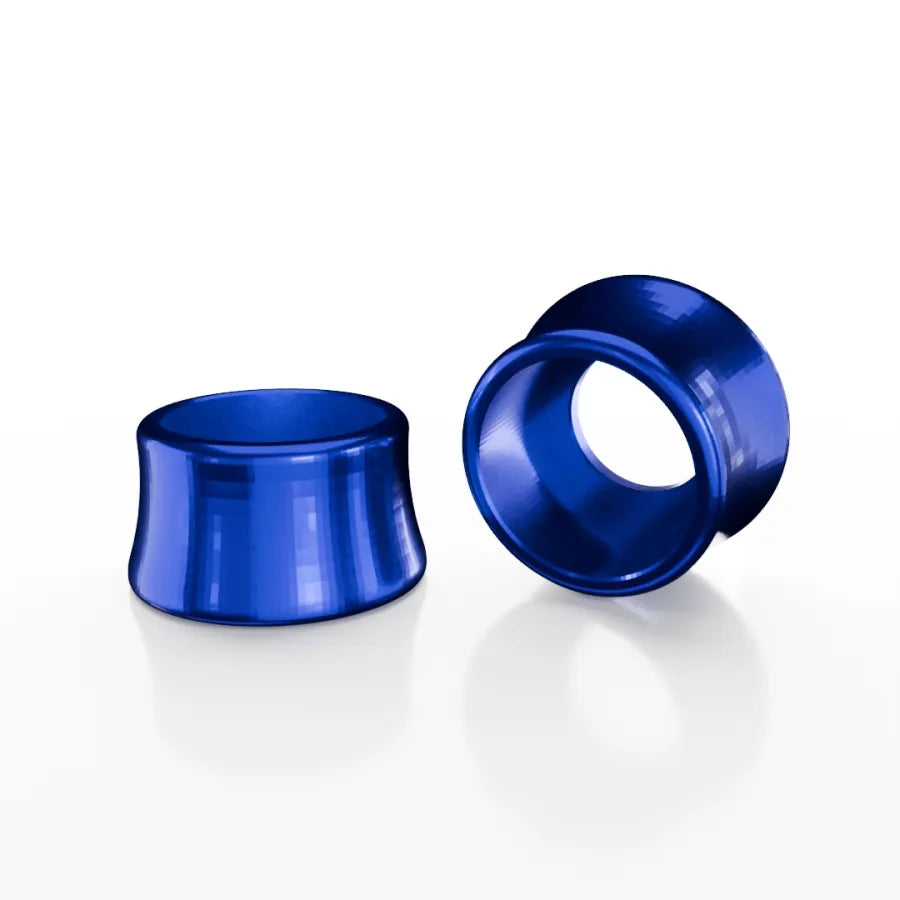 Two SD-X Sniper Evo 10mm Bolt Caps in blue metallic 7075 aluminum are shown on a white background—one stands upright, the other lies on its side to display the hollow center.