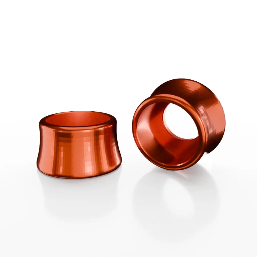 Two metallic, reddish-orange SD-X Sniper Evo 10mm Bolt Caps, crafted from 7075 aluminum and inspired by Sniper Evo designs, are shown for stretched ear piercings—one upright and one on its side against a white background.