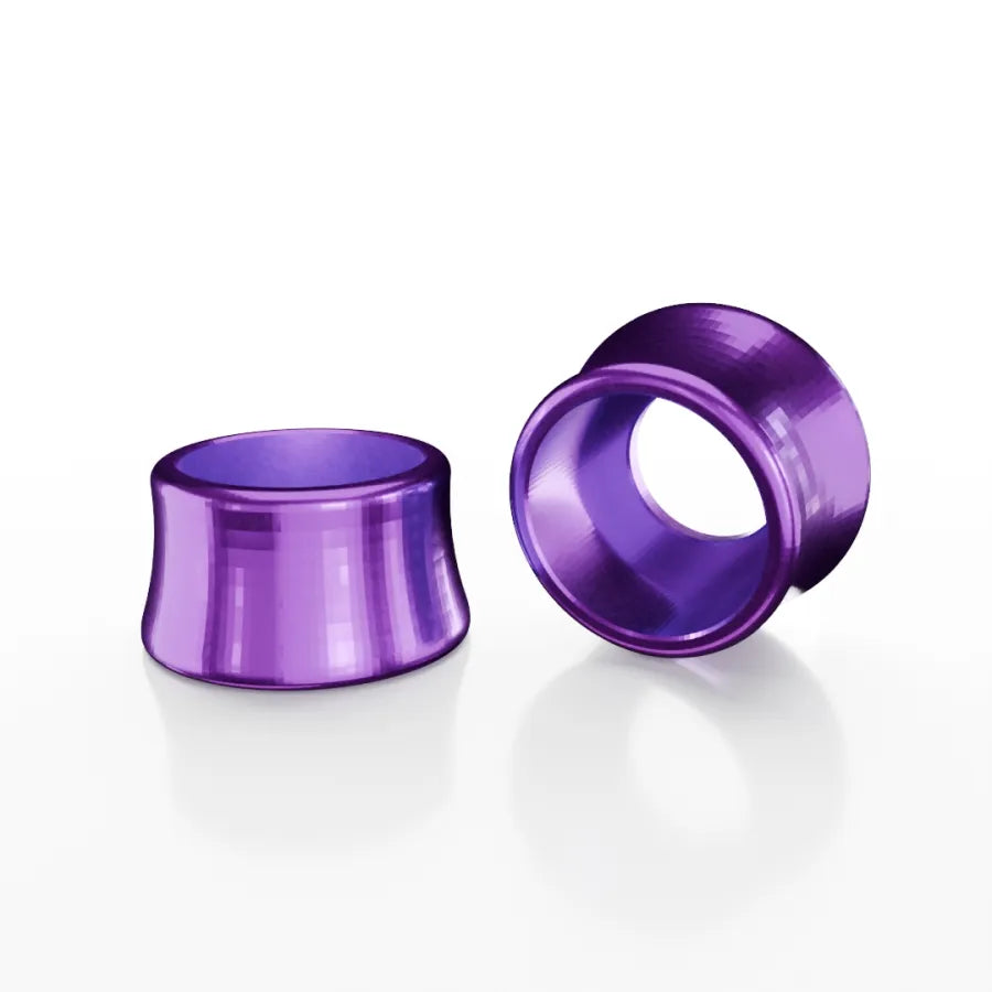 Two SD-X Sniper Evo 10mm Bolt Caps, metallic purple and made from 7075 aluminum, rest on a white surface—one upright, one lying flat—with subtle reflections visible.