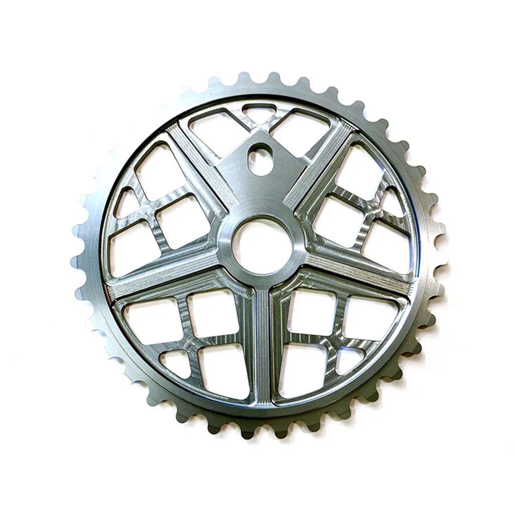 The S&M Motoman Sprocket, CNC machined from 6061 T6 Aluminum and finished in silver, showcases a striking five-spoke design with cut-out sections reminiscent of a Motomag wheel from above.