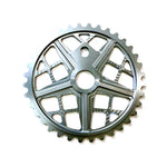 The S&M Motoman Sprocket, CNC machined from 6061 T6 Aluminum and finished in silver, showcases a striking five-spoke design with cut-out sections reminiscent of a Motomag wheel from above.