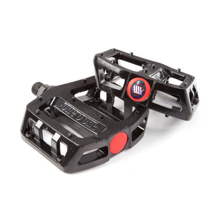 A pair of black S&M 101 Looseball Pedals with a carbon fiber texture on a white background.