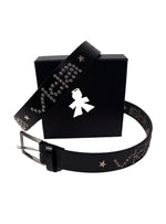 The V1da Studded Leather Belt, crafted from genuine leather with silver studs and star accents, is showcased in front of a black box adorned with a white angel silhouette logo.