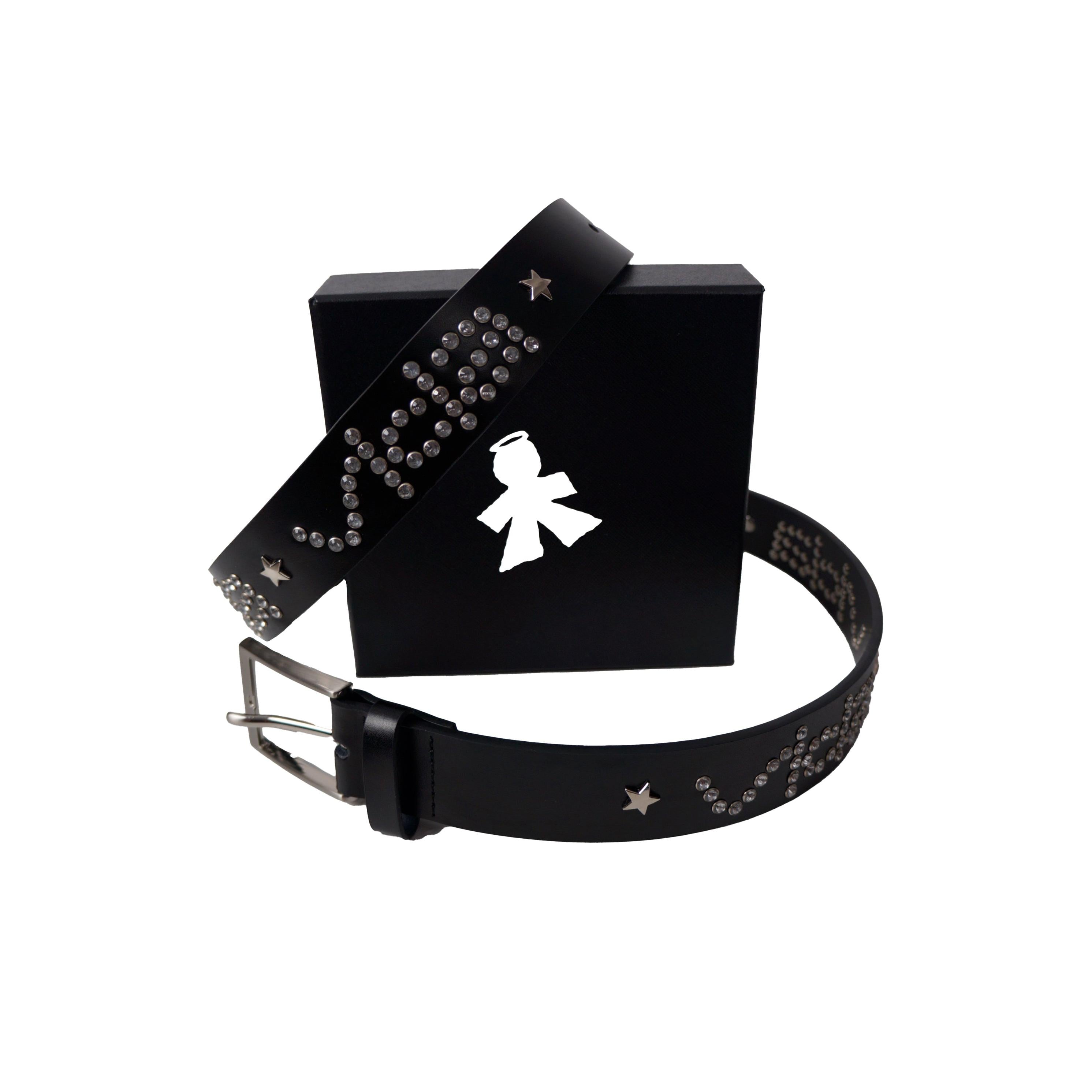 The V1da Studded Leather Belt, crafted from genuine leather with silver studs and star accents, is showcased in front of a black box adorned with a white angel silhouette logo.