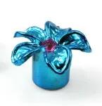A blue metallic Flower Valve Cap with a pink center, resembling a flower and perfect as a decorative valve cap, sits elegantly on a white background.