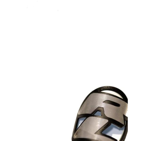 Close-up of a Redline Headtube Badge, featuring geometric metallic cutouts and vintage detailing, set against a white background in the lower right corner.