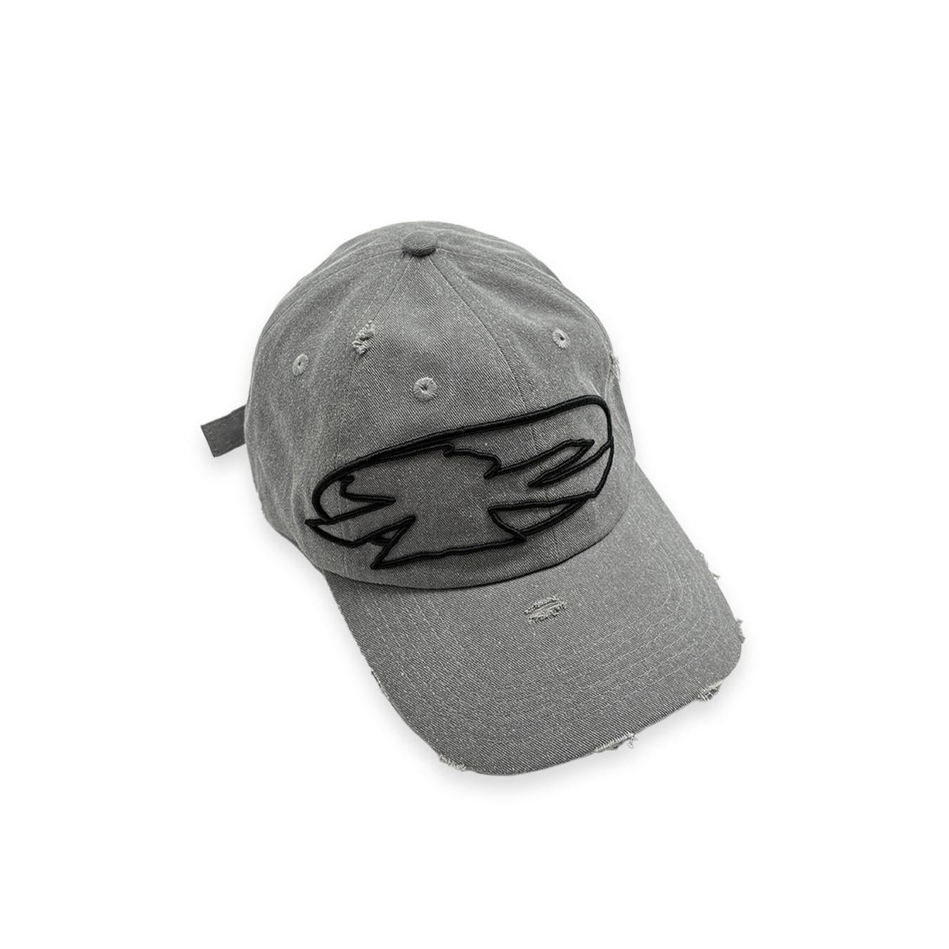 The V1da Shoreline Cap is a distressed gray strapback, crafted from 100% cotton, with a bold black embroidered abstract logo on the front.