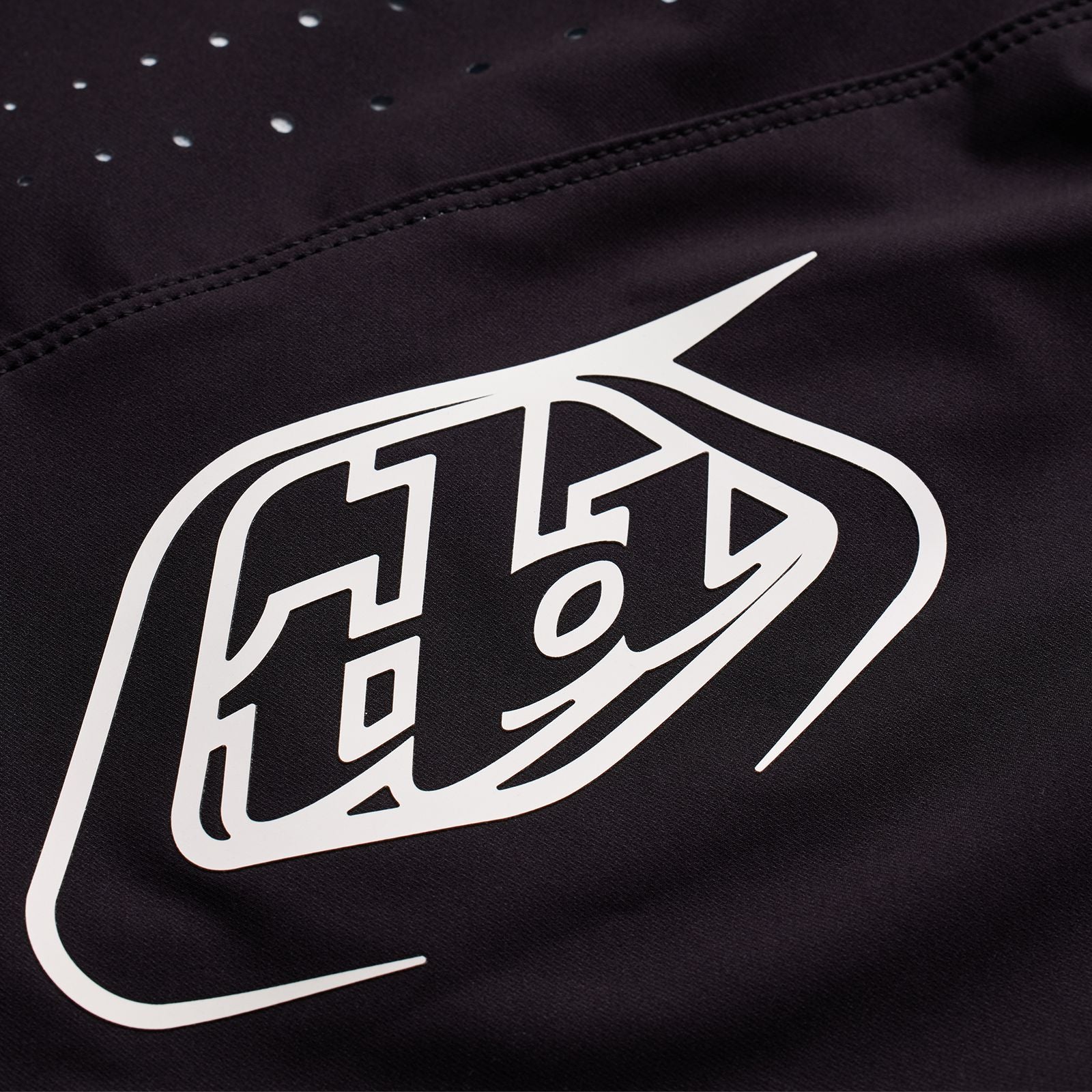The TLD 25.1 Youth Sprint Pant Mono Black is crafted from durable material and features a white logo with stylized text and geometric accents.