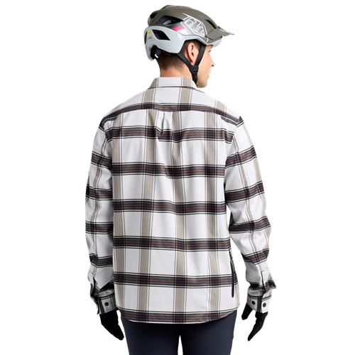 Viewed from the back, a person in a TLD 24.2 Grind Flannel Shirt, equipped with a helmet and gloves, is seen.