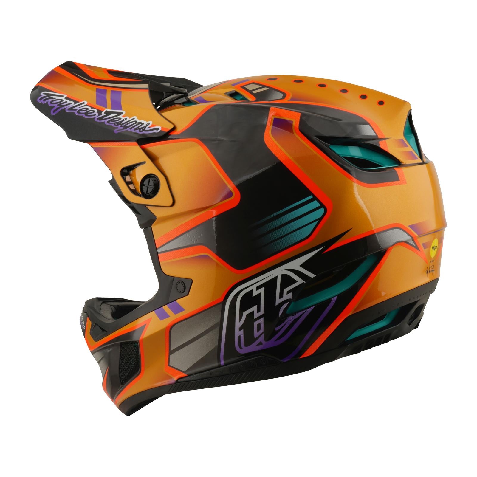 The TLD 26.1 D4 AS Carbon Helmet / Crest Gold is a full-face mountain biking helmet with striking geometric designs—perfect for riders seeking bold style and extra coverage on the trails.