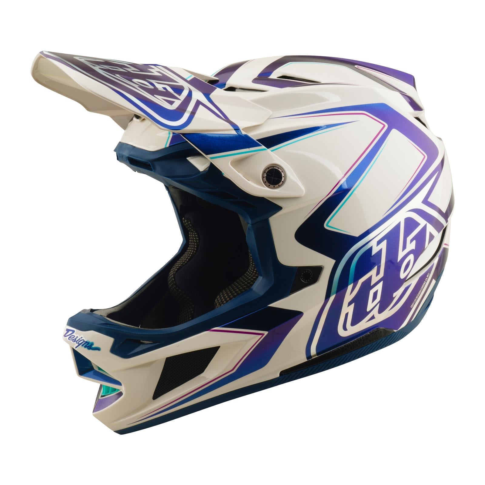 The TLD 26.1 D4 AS Composite Helmet in Flared White/Indigo is an open-face off-road helmet with blue and purple geometric designs, a visor, and Mips protection for enhanced safety.