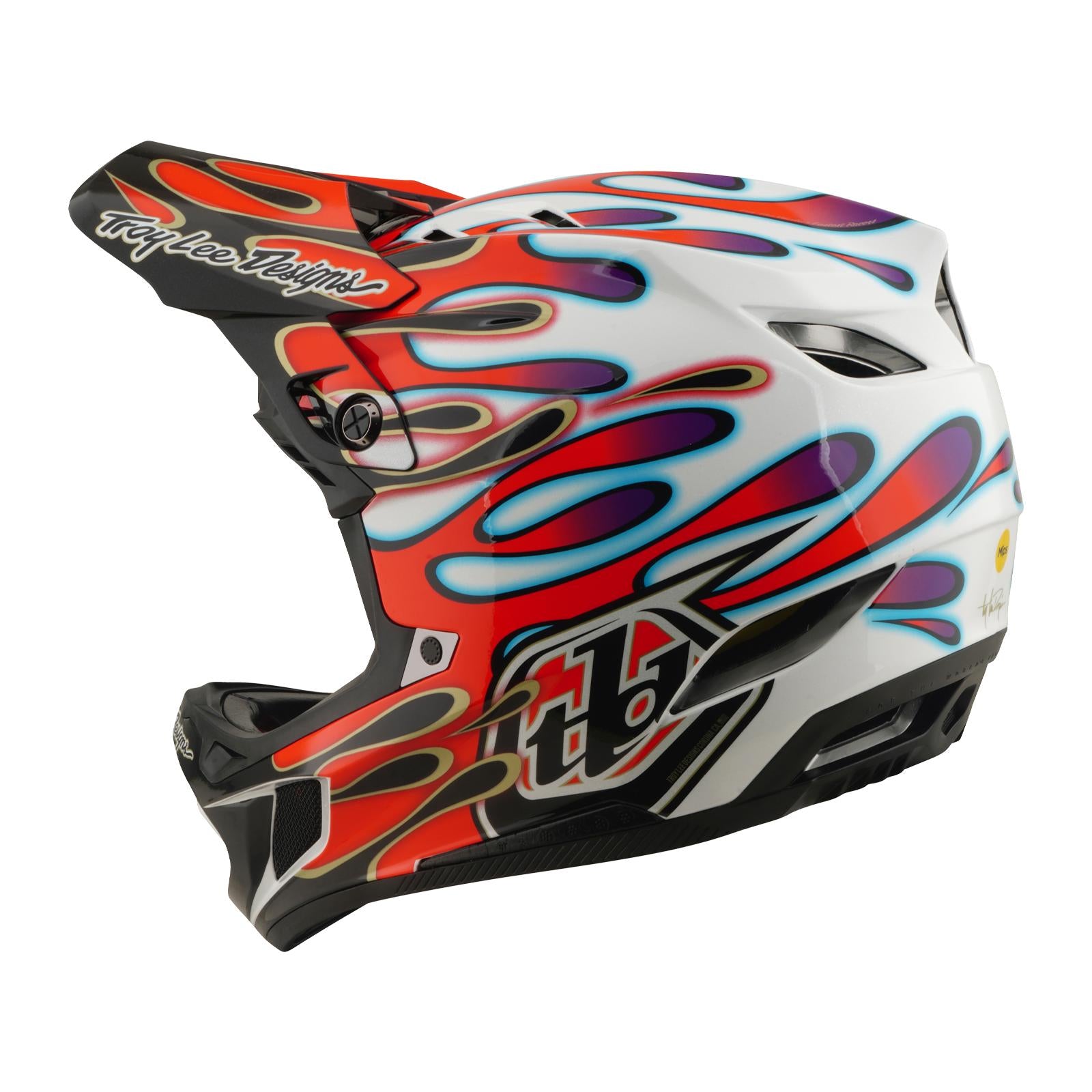The TLD 26.1 D4 AS Composite Helmet in Overspray White/Red features a white base with flame graphics, black visor, ventilation slots, and Mips protection—perfect for BMX or downhill use.