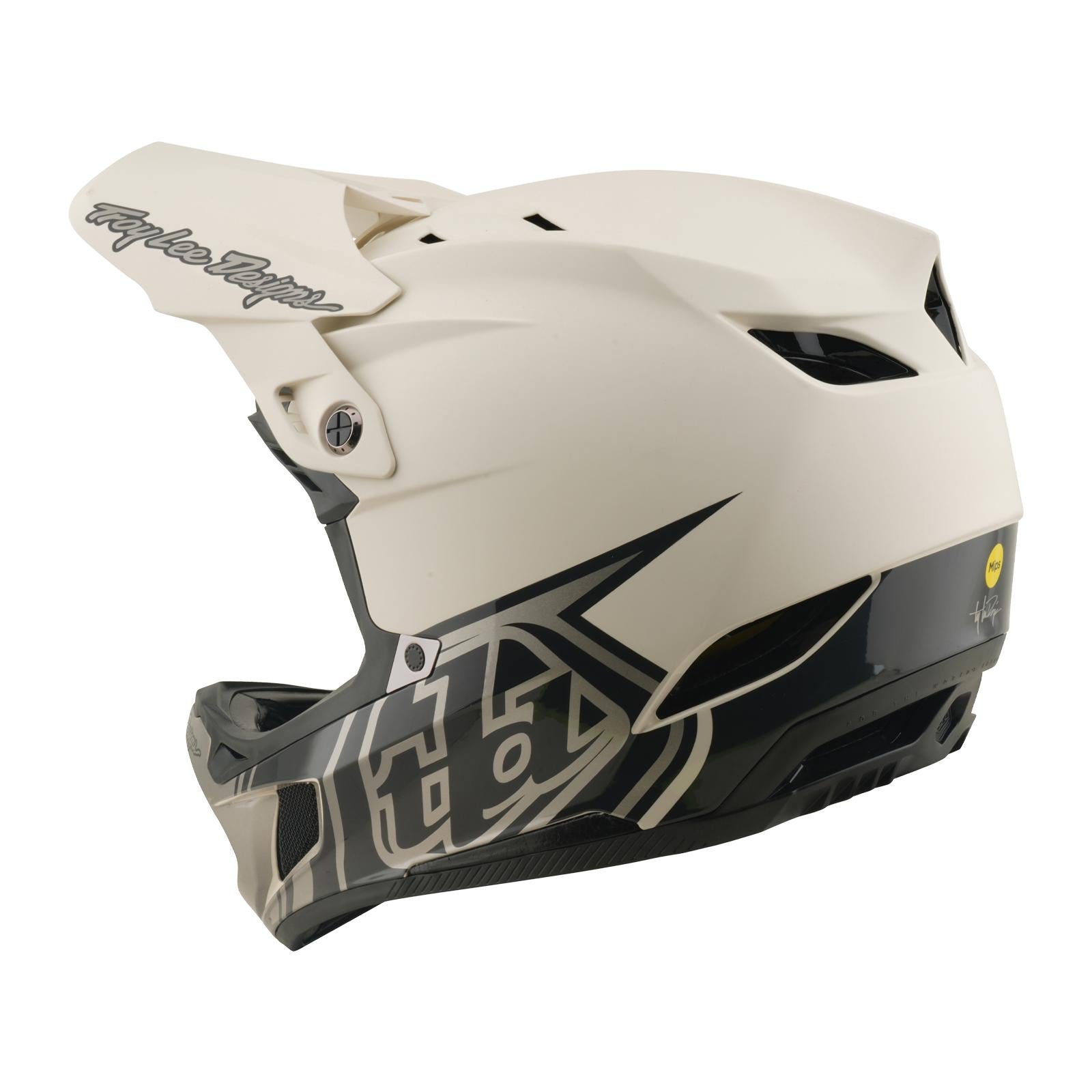 The TLD 26.1 D4 AS Composite Helmet / Stealth Pumice is shown from the side, featuring a white full-face design with black geometric patterns, visor, ventilation, and Mips protection—perfect for BMX riders seeking safety and style.