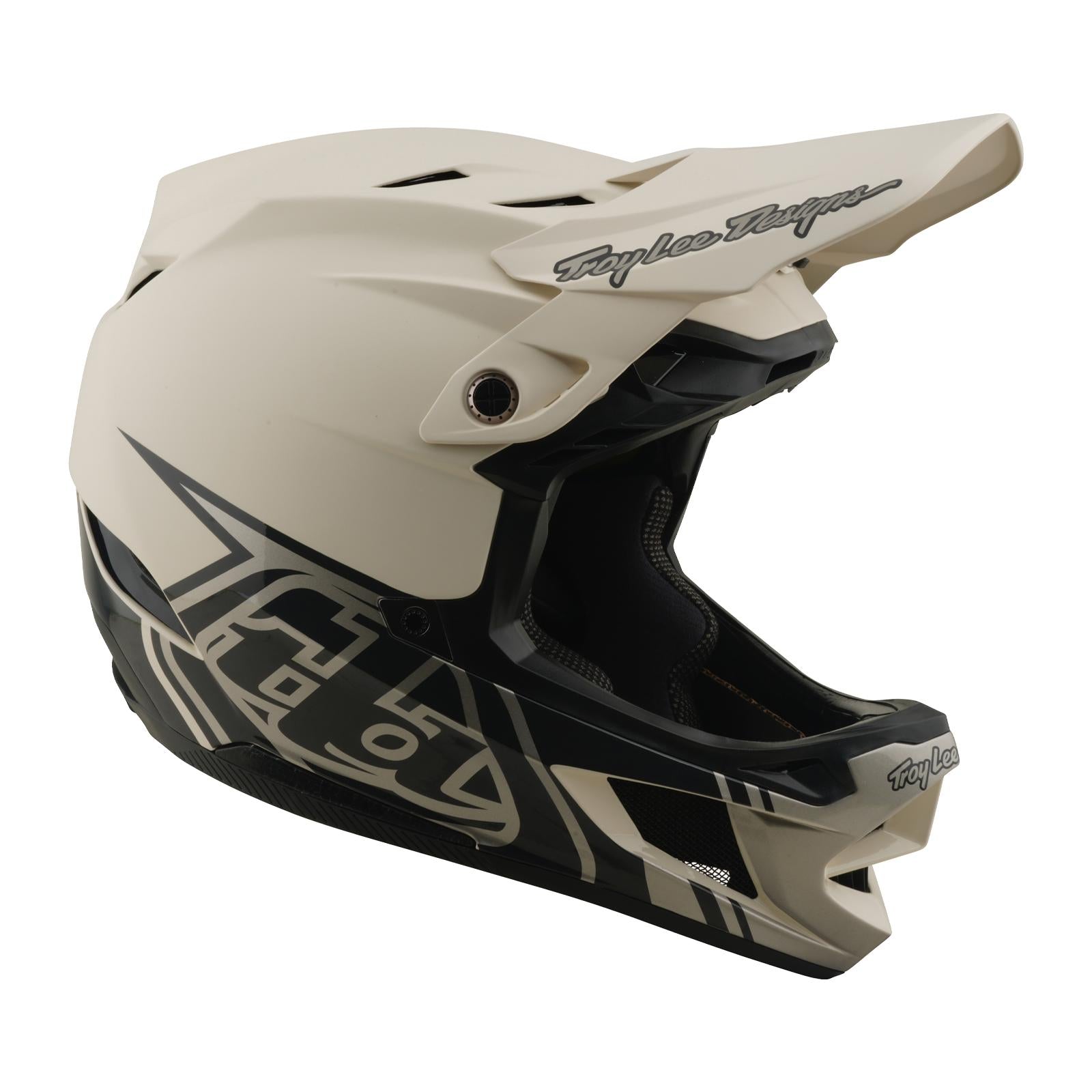 The TLD 26.1 D4 AS Composite Helmet / Stealth Pumice is a beige and black full-face helmet with geometric graphics, visor, Troy Lee Designs branding, and Mips protection—perfect for downhill or BMX riding.