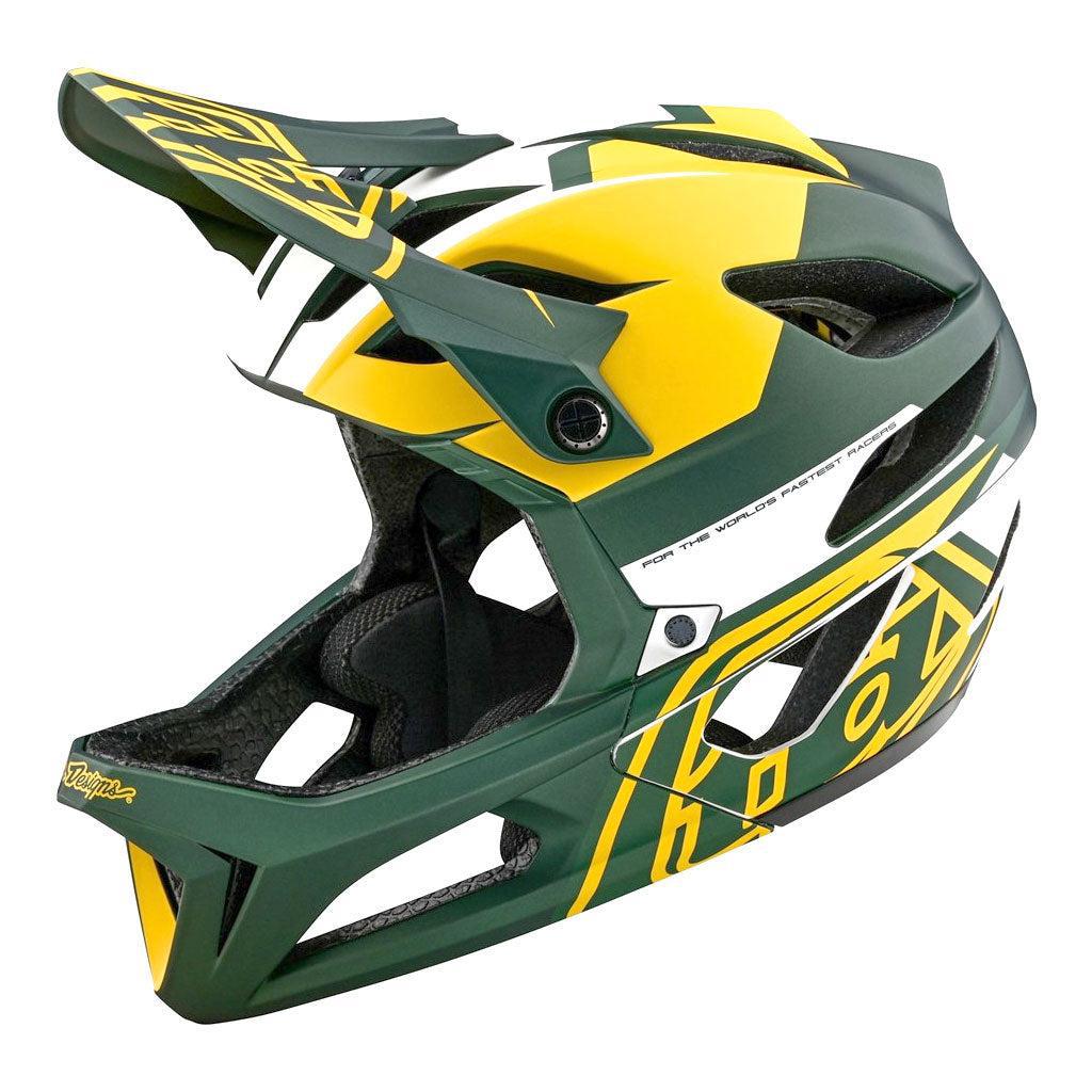 The TLD 24.1 STAGE MIPS AS HELMET is a green and yellow full-face mountain bike helmet with modern design patterns and vent openings, offering enhanced safety for adventurous rides.