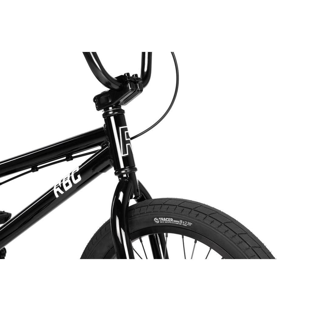 Close-up of the front of the Radio Dice 18 Inch Bike in black, showing handlebars, head tube with decals, Salt Tracer Tyres on the front wheel, and brake cable against a white background.