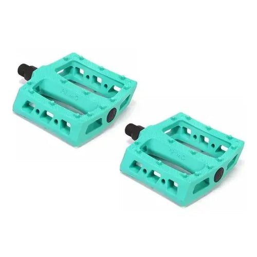 A pair of Primo JJ Palmere Signature Plastic Pedals in turquoise nylon, featuring textured surfaces, black chromoly spindles, and the Primo logo, displayed on a white background.