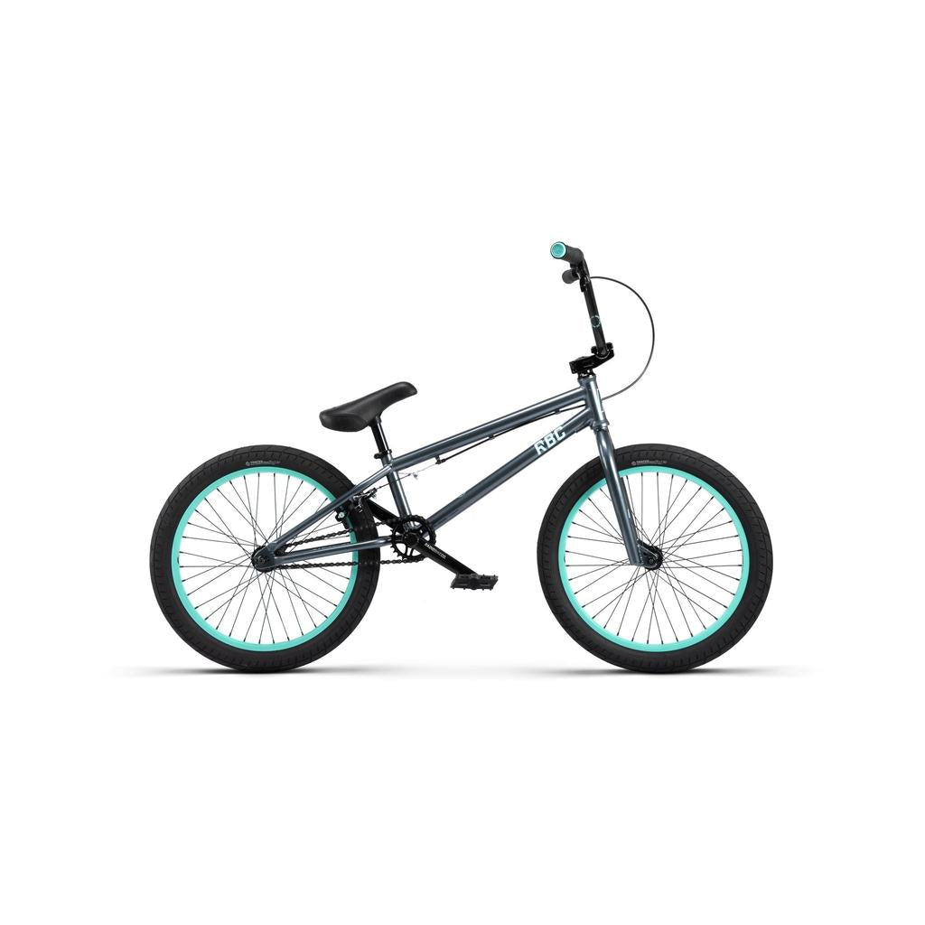 The Radio Saiko 20 Inch Bike is a silver kids BMX with black Salt Tracer Tyres and teal rims, shown in profile on a white background.