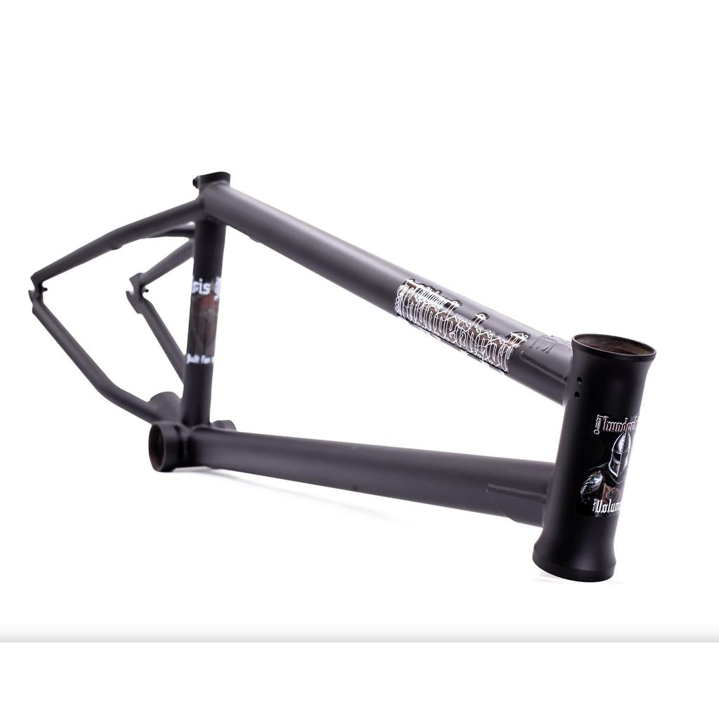 The Kris Fox Thunderhoof Frame is a matte black BMX frame made from heat-treated chromoly, showcasing bold graphics and branding, photographed against a white background.