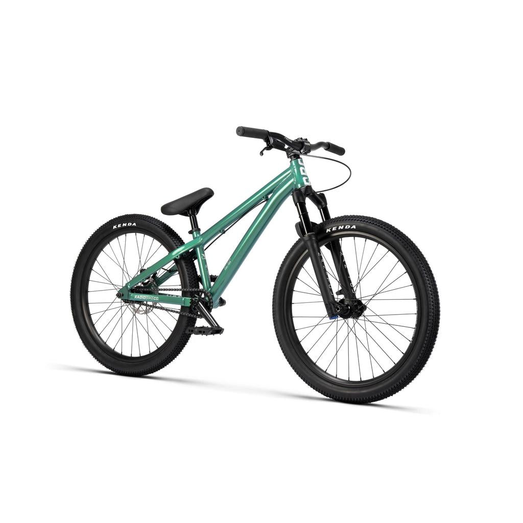 The Radio Griffin 24 Inch Dirt Jumper Bike features a teal frame, black Kenda tires, front suspension fork, single gear, and flat pedals, displayed on a white background.