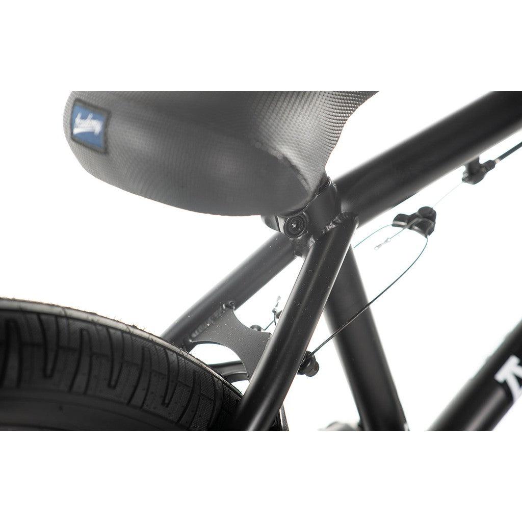 Close-up of a black bicycle's seat, seat post, and rear wheel with visible cables against a white background. This sleek ride, the Academy Entrant 20 Inch Bike, is perfect for those diving into entry-level BMX adventures.