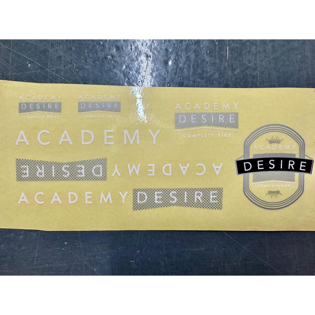 A sheet of purple and white Academy Desire Sticker Pack replacement stickers featuring the words “Academy” and “Desire” in multiple fonts and styles.
