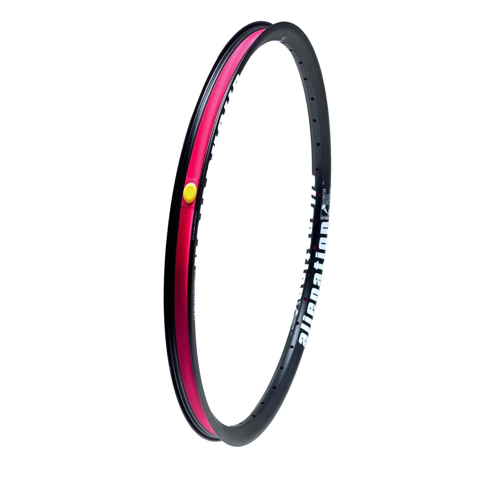 The Alienation Mischief G69 TCS 24 Inch Brakeless Rim features a black exterior adorned with "alienation" text and a vibrant red interior stripe, offering an angled view. Made from G69 material, this rim ensures durability and performance for dedicated cyclists.