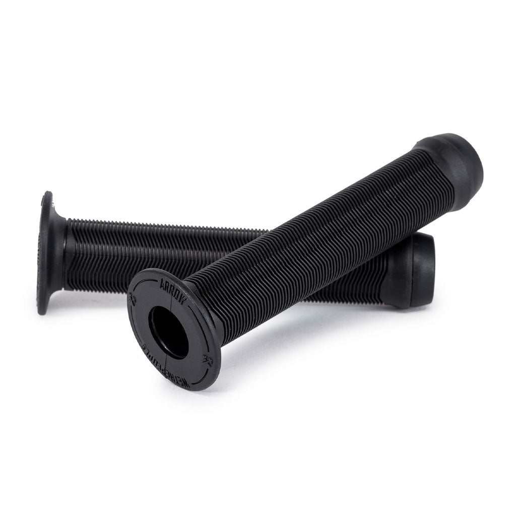 The Wethepeople Arrow (Junior) Grips, featuring a sleek design in black, include two grips made from high-quality vex-k6 rubber. One grip is positioned horizontally and the other diagonally, providing superior comfort and control for young BMX riders.