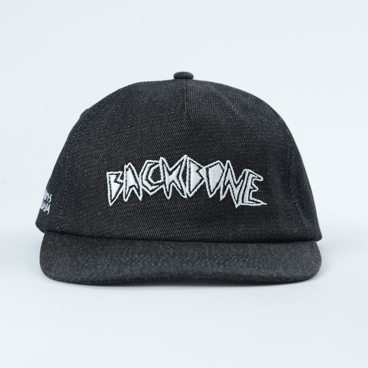 The Backbone Always Building Hat is an unstructured 5-panel black cap with "BACKBONE" boldly embroidered in white stylized letters on the front.