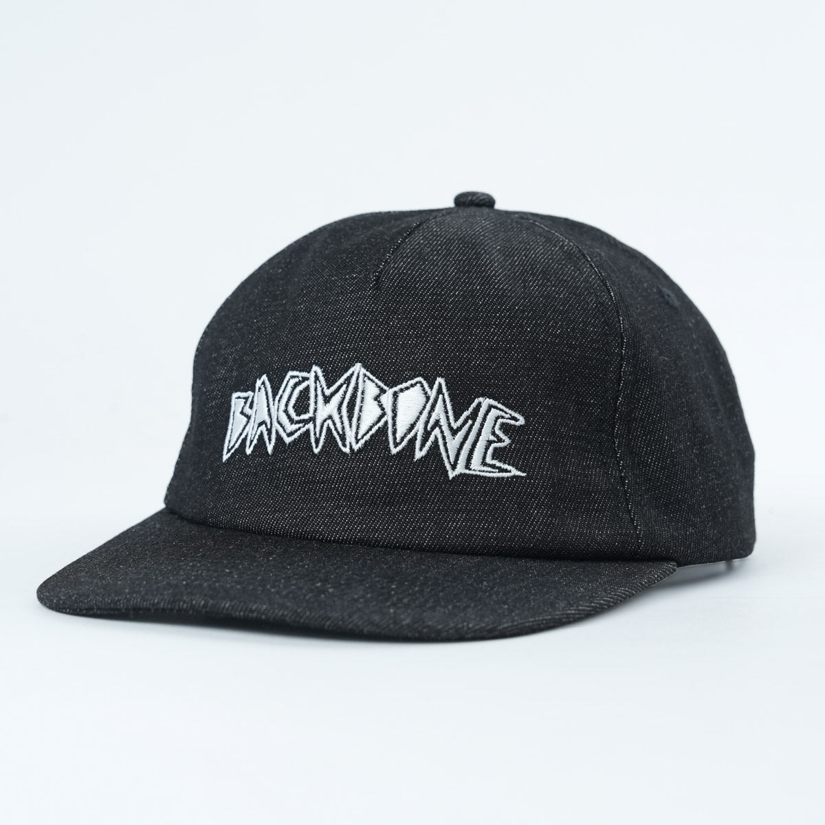 The Backbone Always Building Hat is a black, unstructured 5-panel cap featuring "BACKBONE" embroidered in bold white stylized lettering on the front, shown against a plain white background.