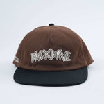 The Backbone Always Building Hat is a brown and black unstructured hat featuring "BACKBONE" embroidered in white on the front, ideal for Backbone BMX enthusiasts.