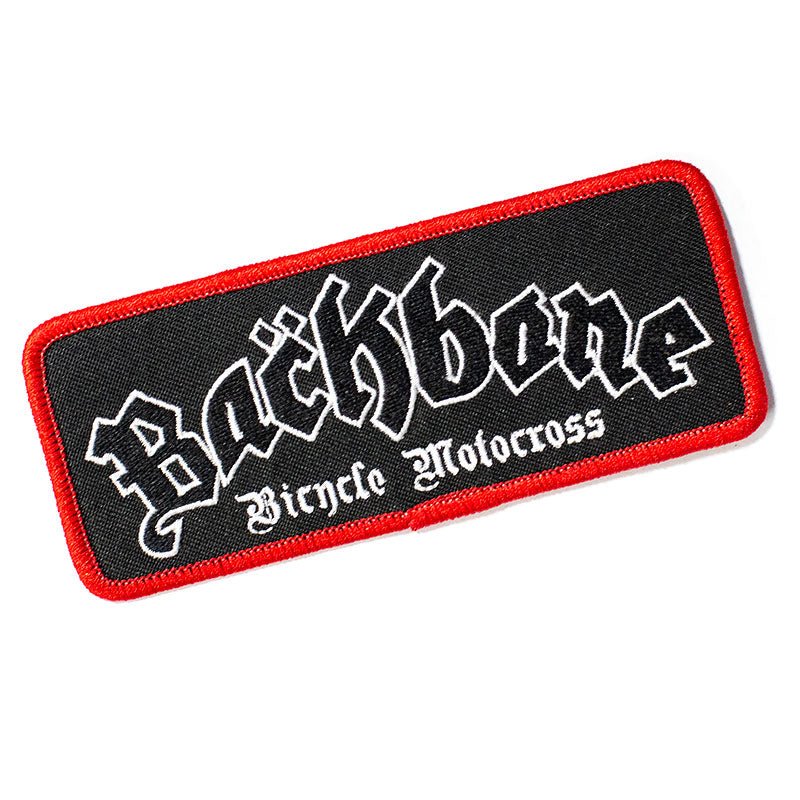 The Backbone Road Crew Patch is rectangular with a bold red border and features "Backbone Bicycle Motocross" in stylized white font on a sleek black background, perfect for adding flair to jackets.