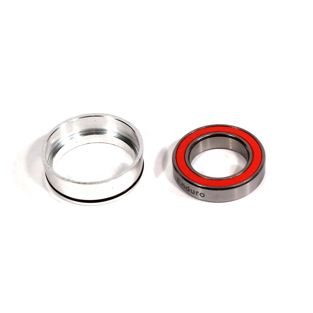 Two metal components on a white background: a silver bearing sleeve and a round ball bearing with red seal labeled "Enduro," designed as the Profile Hub Body Bearing AC-2 Hub (Ceramic) for applications needing angular contact bearings.