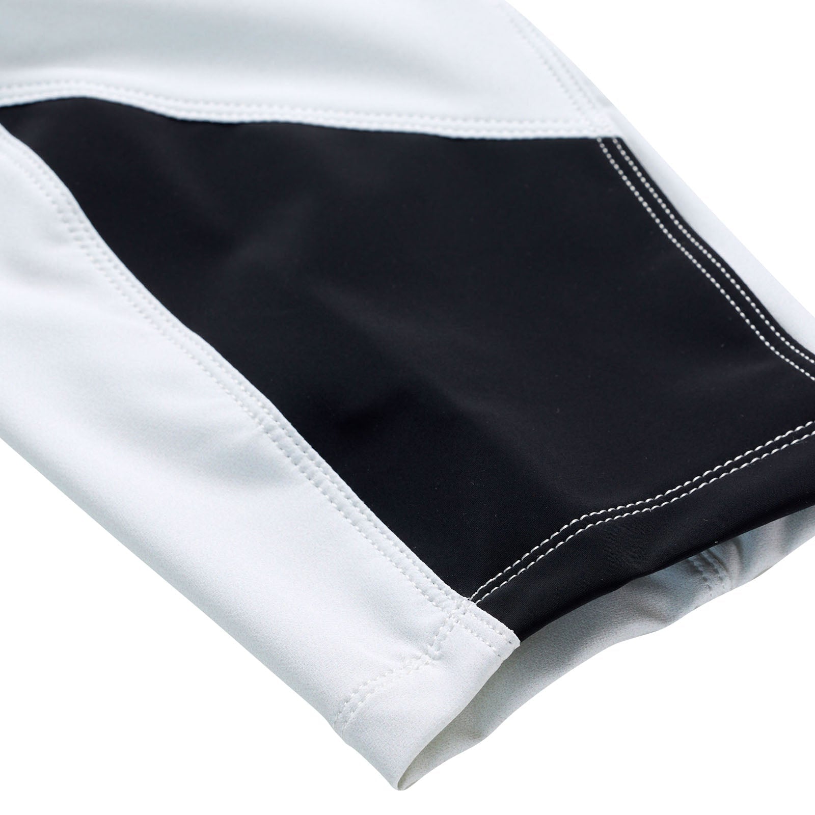 Detailed close-up of the TLD 25.1 Sprint Pant in Mono Chalk, showcasing its race-ready white fabric with a black geometric design and visible stitching, ideal for sprint kit enthusiasts.