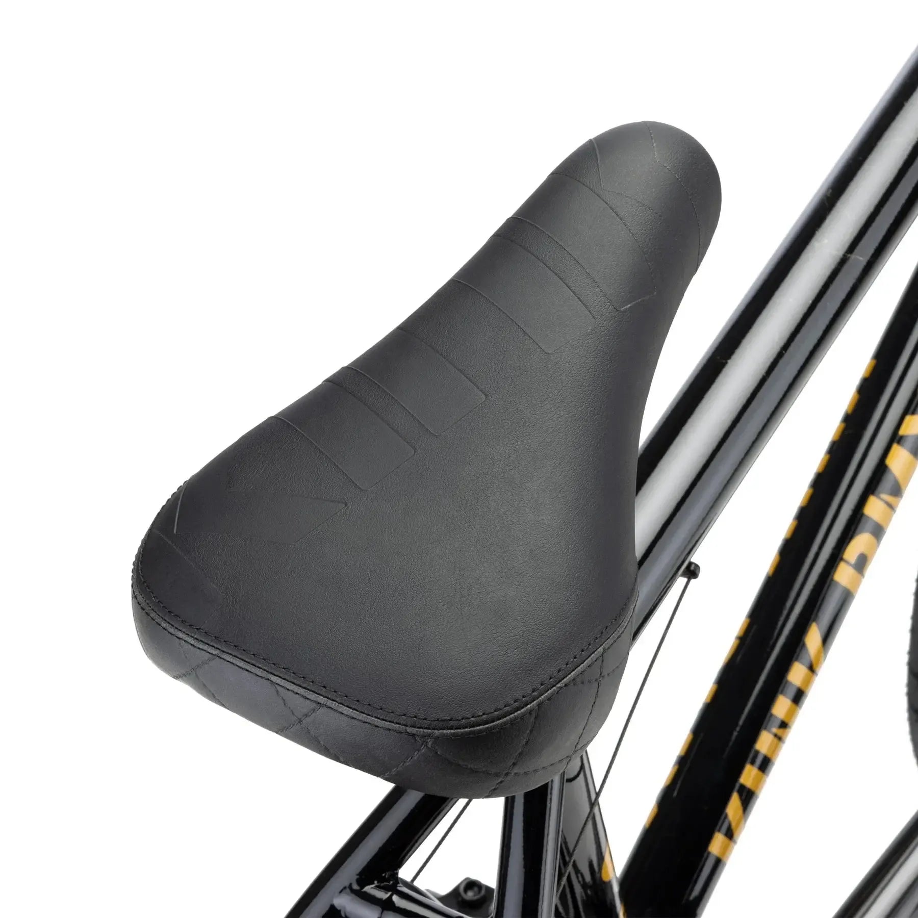Close-up of a black bicycle seat on the Kink Gap 20 Inch Bike (2026), showcasing textured stitching and saddle details against the sleek 4130 chromoly frame.