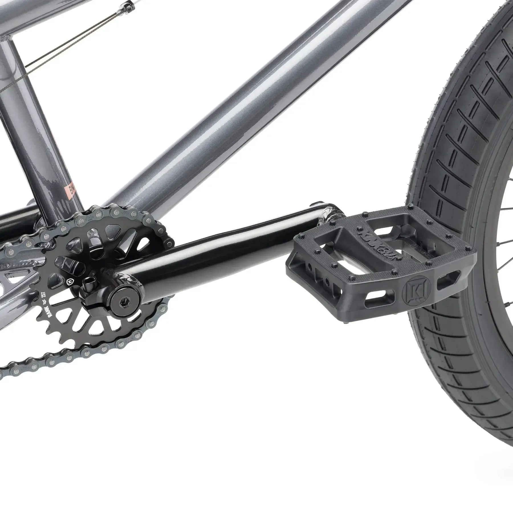 Close-up of the Kink Kicker 18 Inch Bike (2026) crankset, pedal, chainring, rear wheel, and frame, highlighting detailed components ideal for freestyle BMX riding.